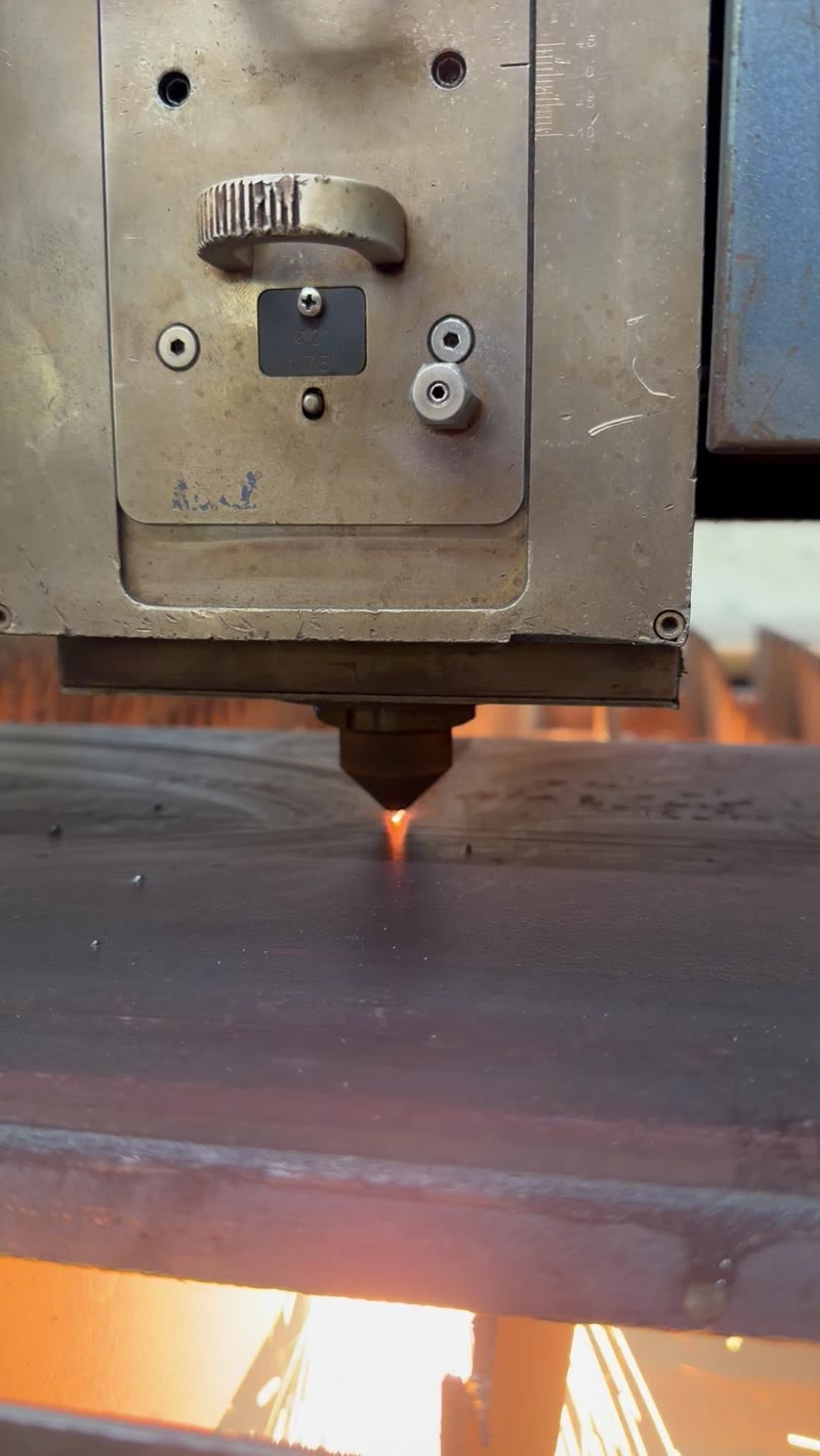 Laser cutting metal close-up with orange glow